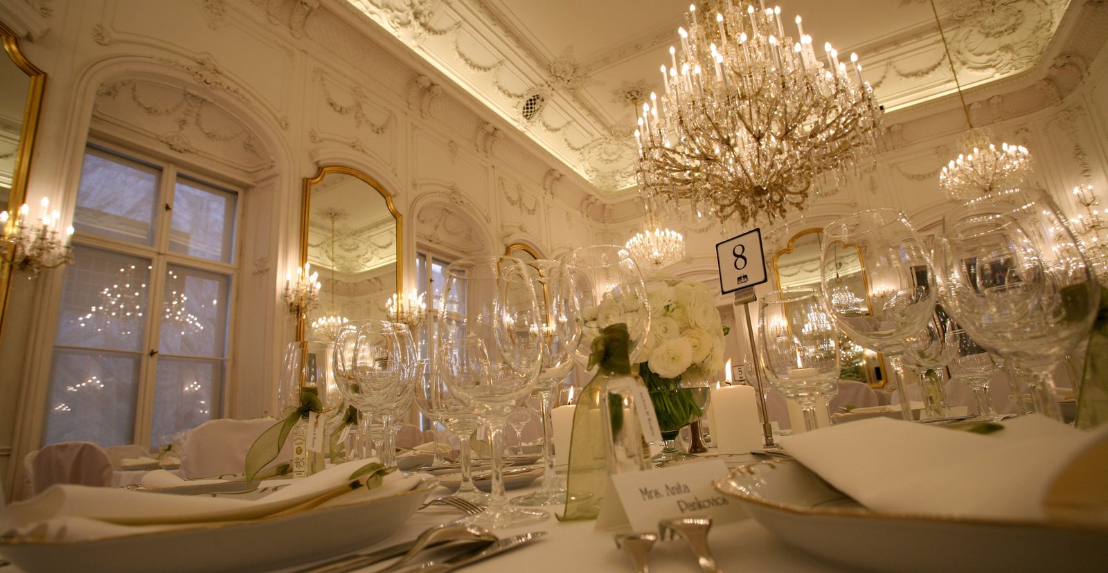 A very elegant dinner venue set in a castle, beautifully arranged for the wedding.