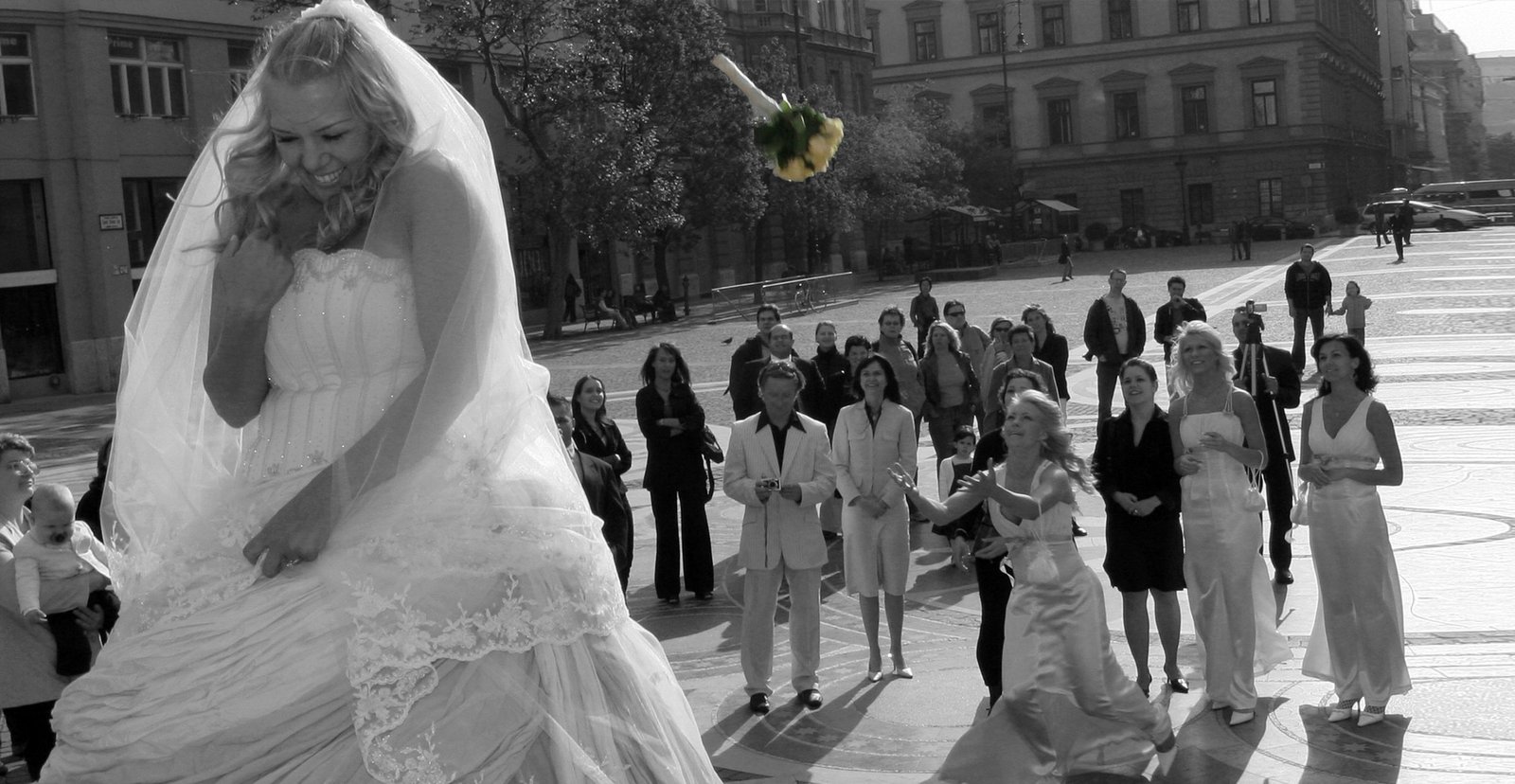A very emotional moment: the bride tosses her bouquet and giggles, wondering who will catch it.