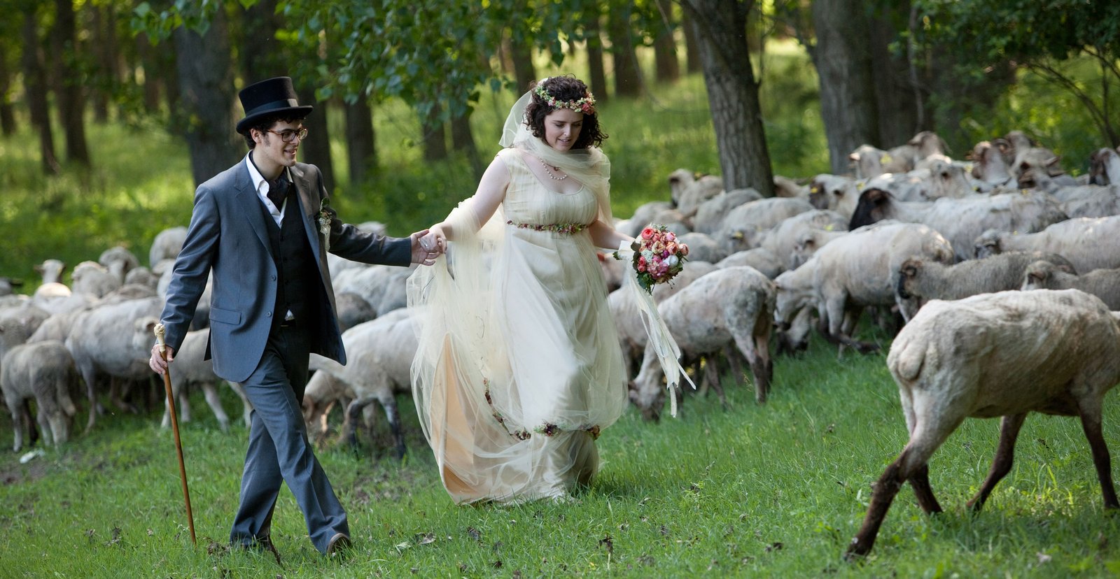 A fairytale wedding scene in nature with sheep, magical and dreamlike atmosphere.